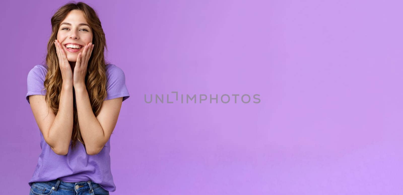 Cheerful lovely cute smiling happy girl grinning delighted touch cheeks having fun enjoy summer warm days look happily express positivity friendship stand purple background by Benzoix