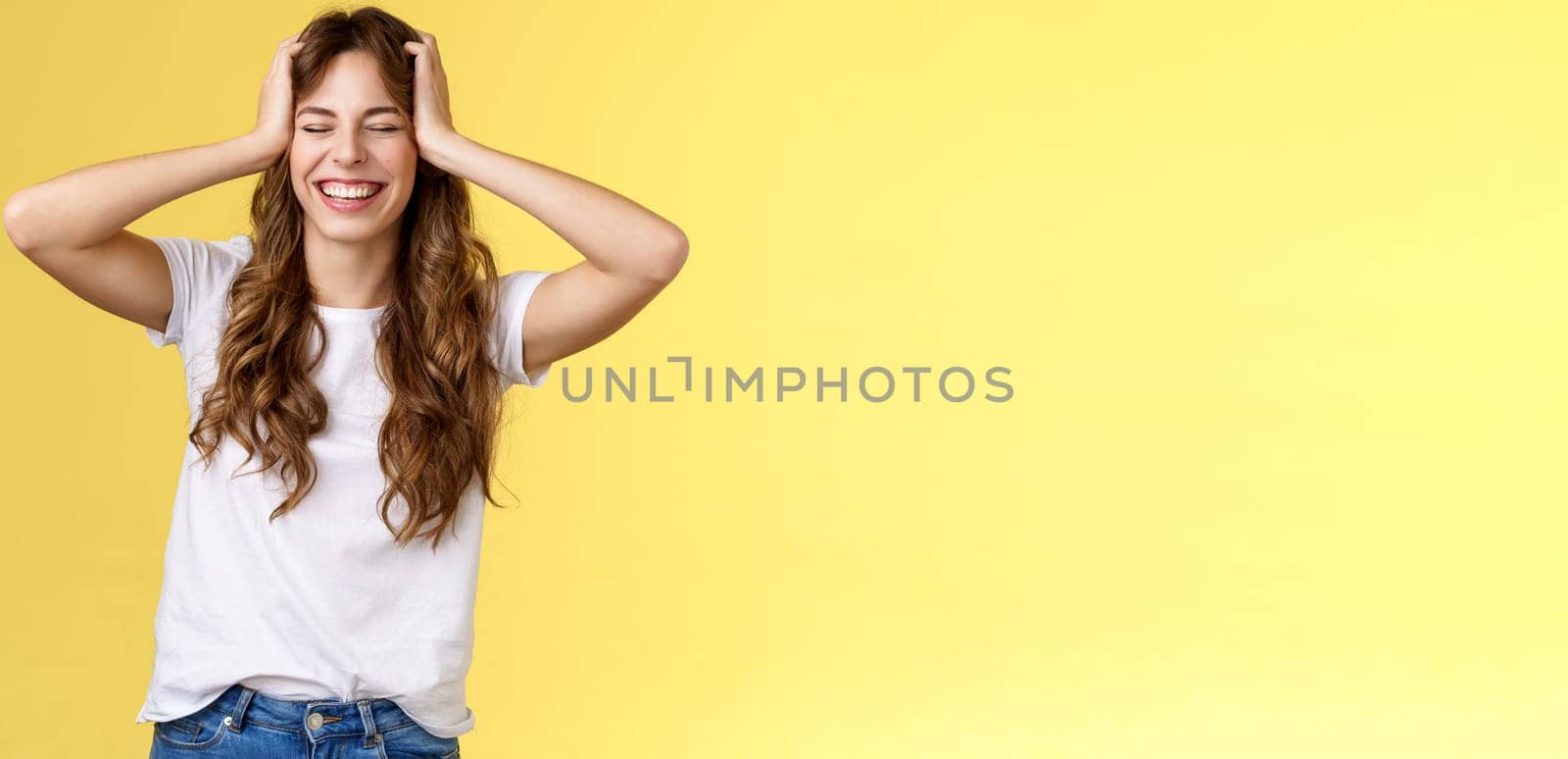 Joyful happy enthusiastic good-looking girl receive unbelievable awesome opportunity travel summer vacation abroad grab head close eyes smiling happily triumphing upbeat yellow background.