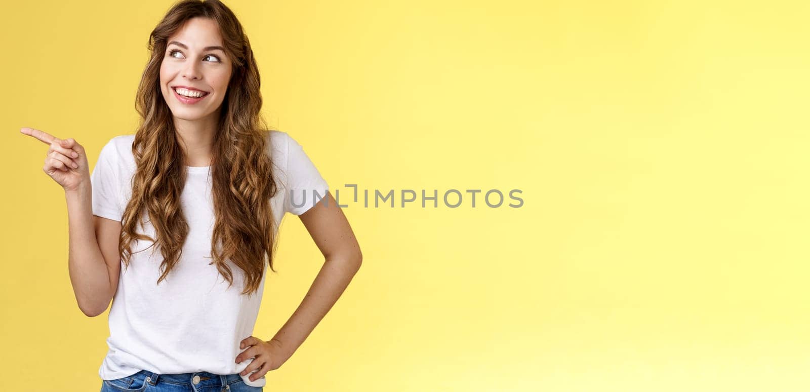 Dreamy silly tender caucasian girl picking making choice shopping together friend smiling curious satisfied found perfect variant look pointing upper left corner thoughtful interested grin delighted. Lifestyle.