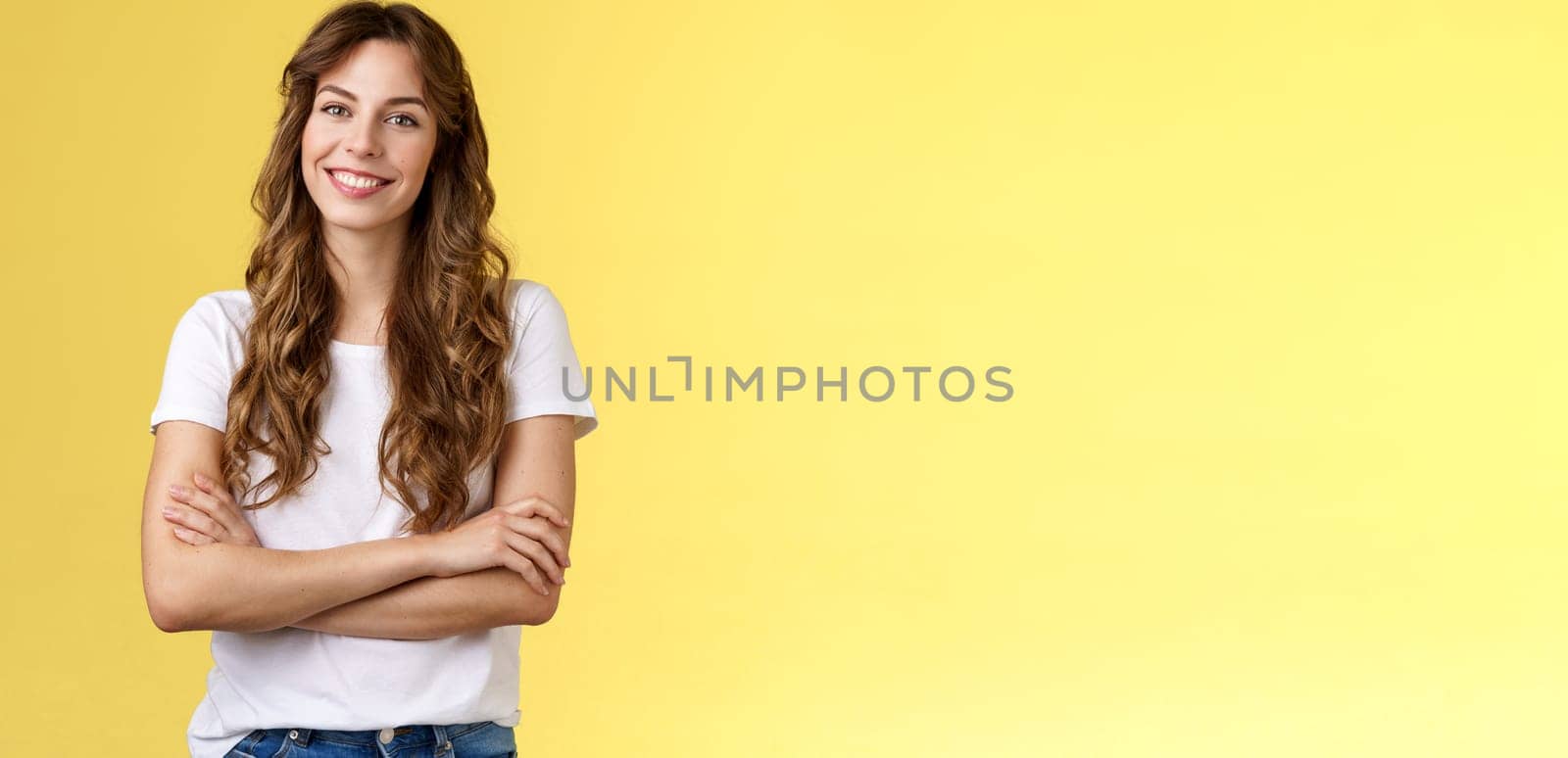 Confident carefree lively smiling female freelancer professional cross arms chest self-assured pose stand comfortable white t-shirt grinning toothy delighted stand yellow background friendly.
