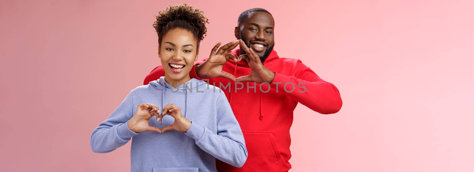 Charming joyful caring young african american family man woman siblings smiling broadly show heart gestures grinning express love empathy positivity, two loyal friends cherish friendship.