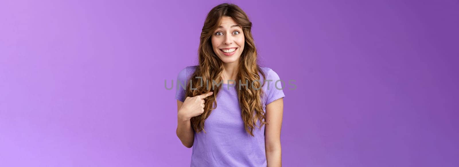 Who me awesome. Surprised silly tender delighted happy girl smiling impressed amazed pointing herself raise eyebrows astonished not expect hear own name stand purple background winning event by Benzoix