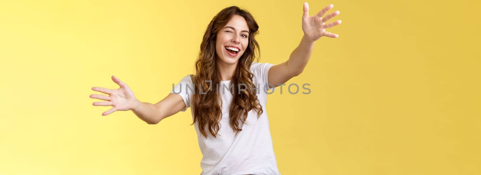 Girl cheering up sad friend wanna comfort girlfriend winking upbeat optimistic attitude extend arms towards camera cuddling reaching you give hug embracing guest smiling broadly invite come in. Lifestyle.