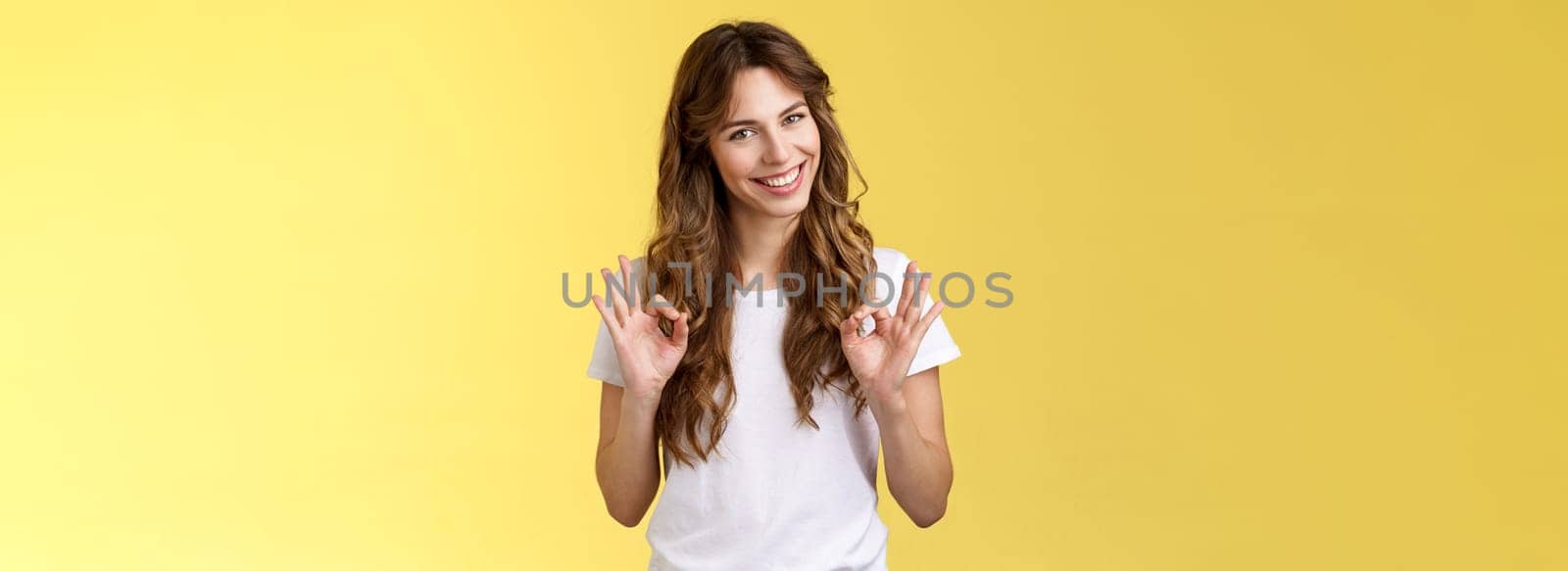 Not bad for newbie. Cunning good-looking young creative female colleague guarantee excellent result show okay ok approval gesture, assure friend everything perfect stand yellow background assertive by Benzoix