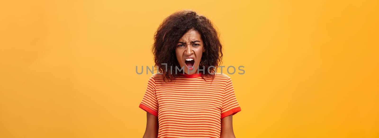 Not fair you broke promise. Portrait of offended displeased moody african american girlfriend with curly hair yelling and complaining making displeased grimace shouting at camera from offence. Emotions concept