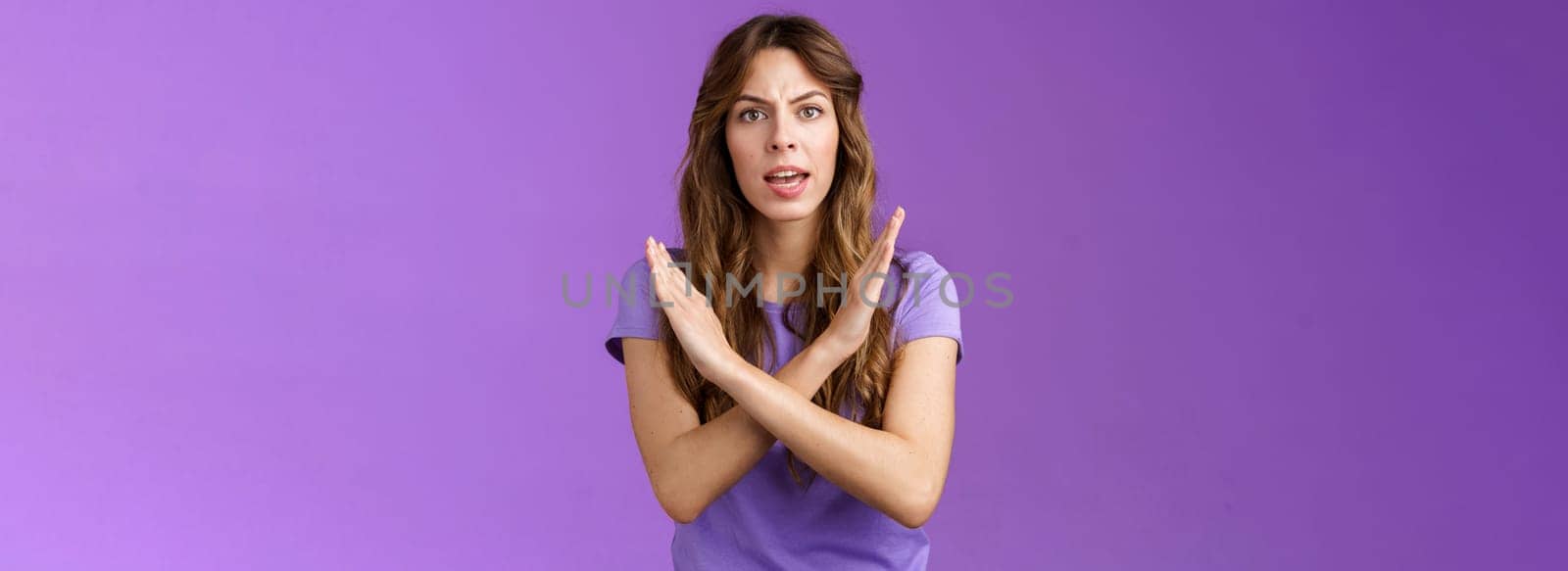 Quit fooling around. Serious-looking woman bad mood bossy angry make cross fighting lgbtq rights demand stop discrimination forbidding cruel behaviour say no purple background.