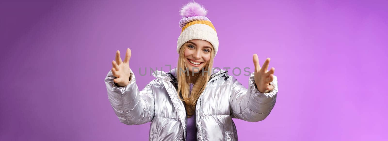 Friendly romantic joyful charming blond european woman asking boyfriend come give hug tilting head happily smiling extend arms forward cuddle wanna embrace loving person snowy mountain travel by Benzoix