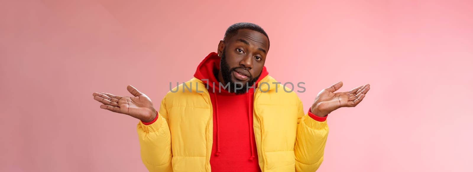 Indoor shot black bearded 25s guy shrugging hands raised sideways dismay clueless gesture have no idea standing careless questioned unaware what happened unbothered pink background. Copy space