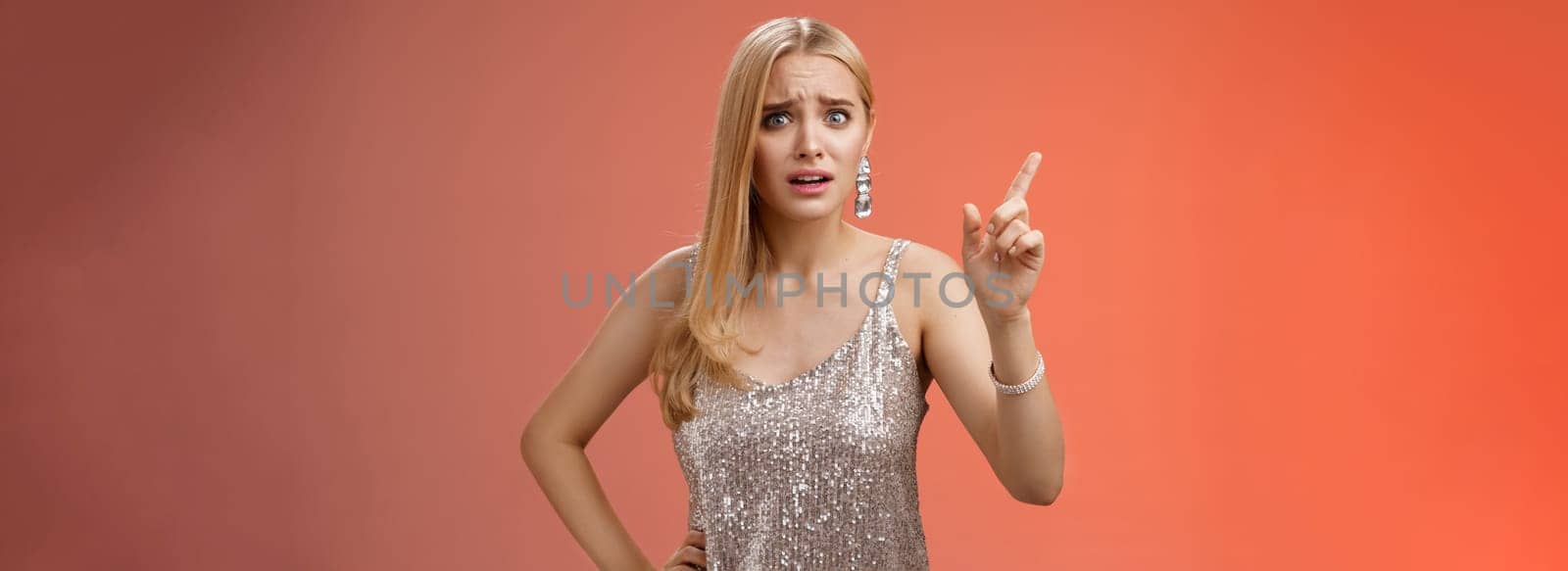 How could you. Disappointed let down upset complaining young woman demanding respect raise index finger scolding teaching lesson give instructions standing bothered displeased, red background.