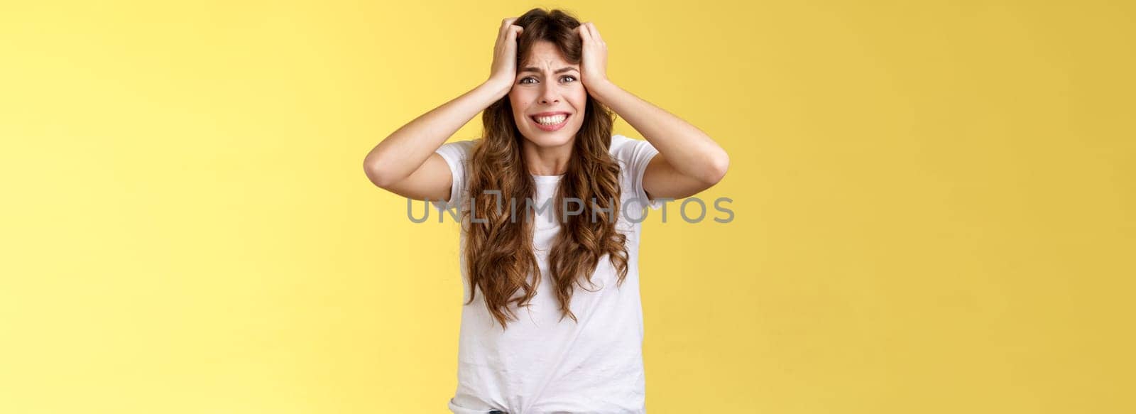 Girl panicking huge trouble suffer panic-attack grimacing painful feelings inside hold hands head troubled frustrated frowning anxiously staring camera troublesome problematic situation by Benzoix