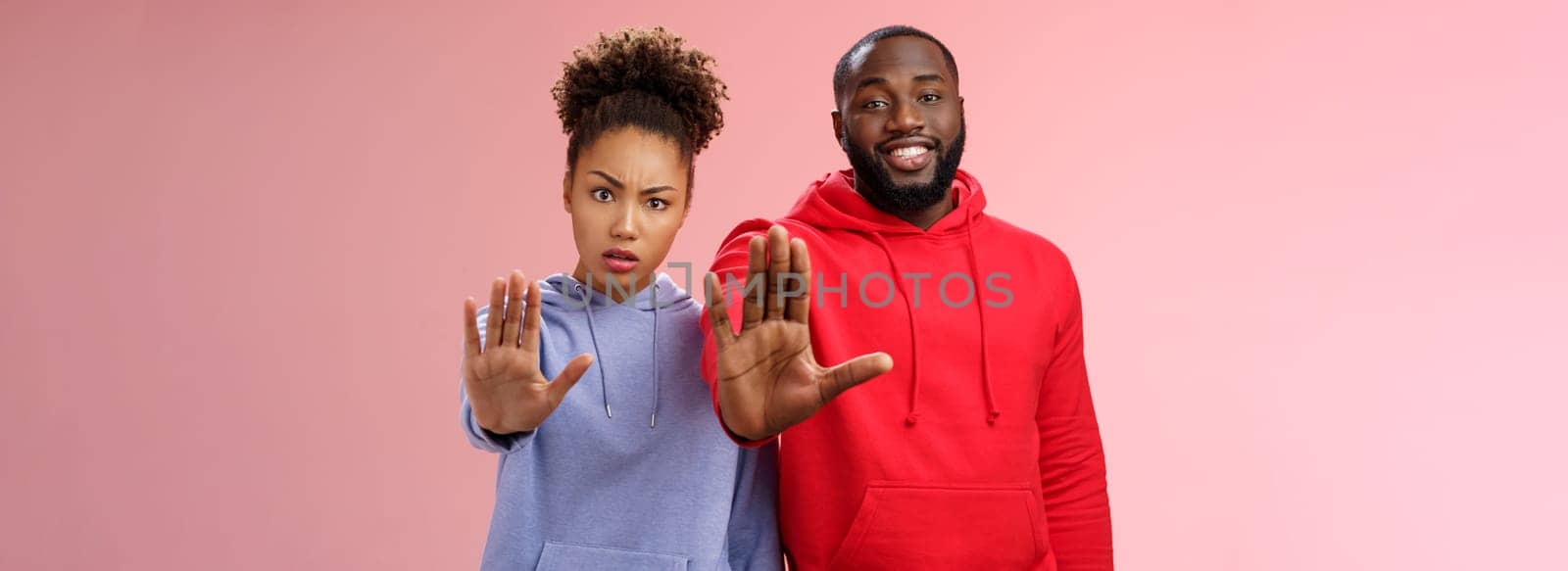 Friend asking stop worrying health raise palm forbidden enough dangerous gesture. Two african american man woman show hand prohibition taboo gesture persuading quit smoking, pink background by Benzoix