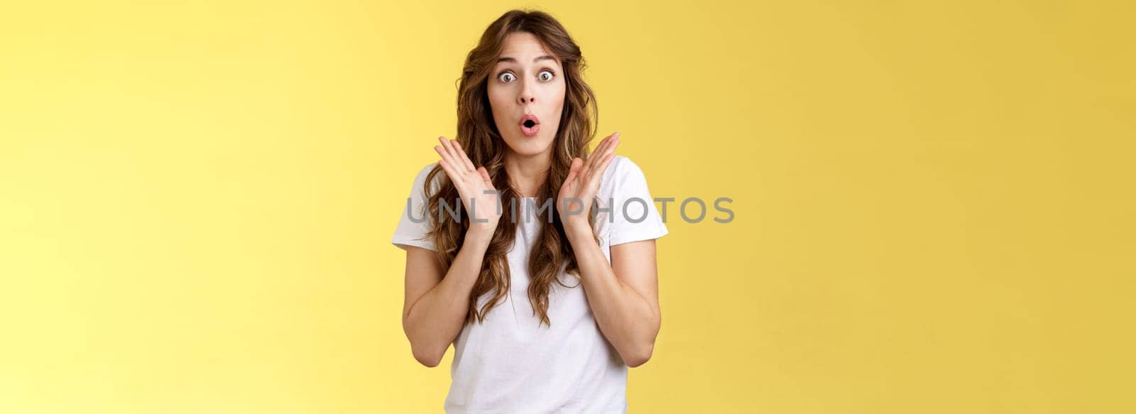 Shocked impressed surprised girl learn interesting pleasant good news clap hands open mouth fold lips wow gasping stare intrigued enthusiastic reaction awesome performance yellow background by Benzoix