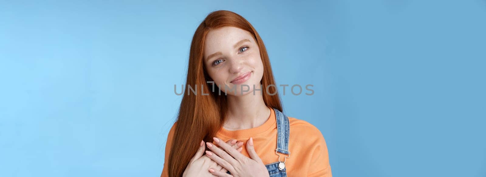 Touched romantic tender cute redhead feminine girl blue eyes tilting head melting heartwarming gesture receive gladly pleasant prest touch heart smiling grateful, feel romance love, blue background by Benzoix