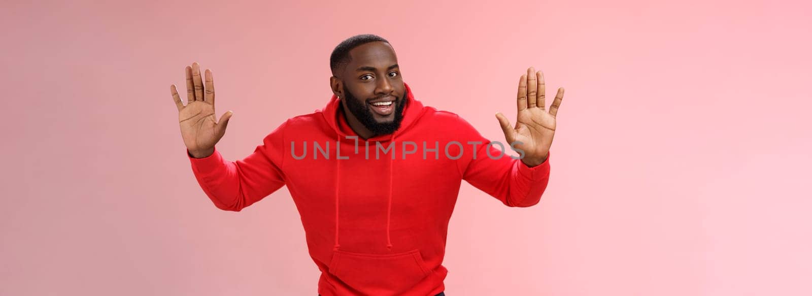 Happy charming outgoing african american male model raise hands joking standing surrender smiling give up girlfriend won grinning agree go dinner restaurant, standing pink background.
