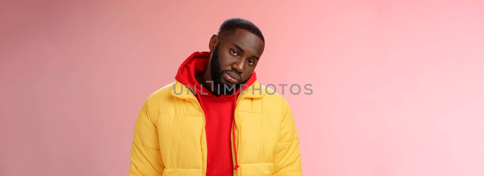 Unimpressed bored ignorant young african bearded man tilt head look scorn uninterest camera listen boring useless information, standing careless in yellow jacket red hoodie, indifferent by Benzoix