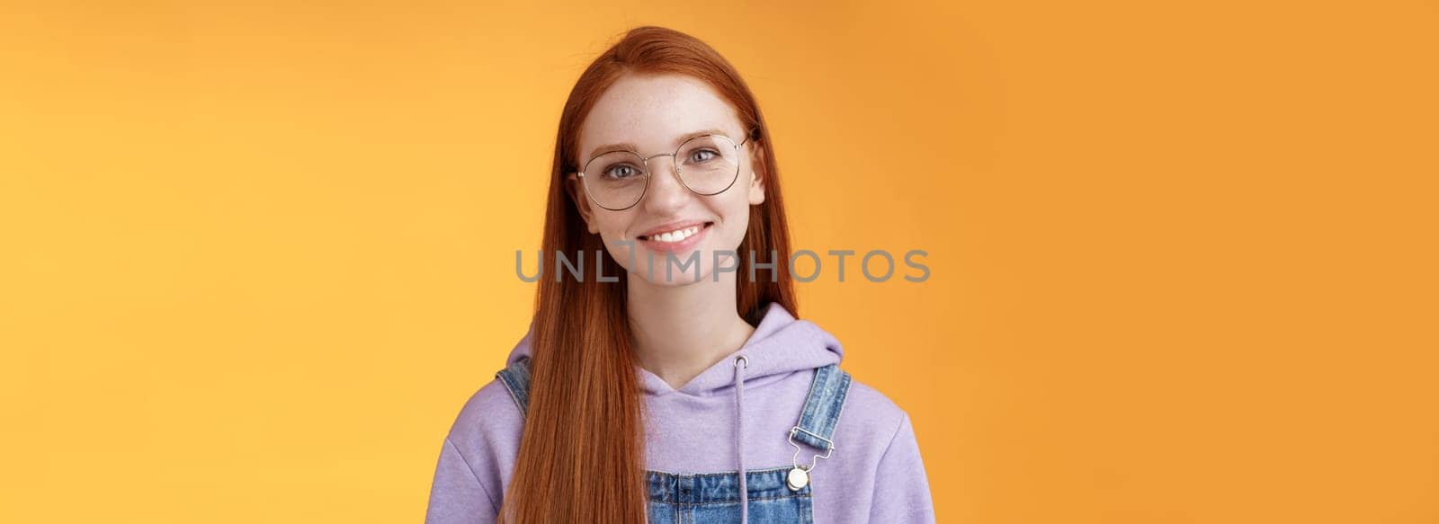 Charming smart cute female freelancer order coffee working cafe standing overalls glasses hoodie smiling delighted talking casually barista orange background have happy relaxing day feel joyful by Benzoix