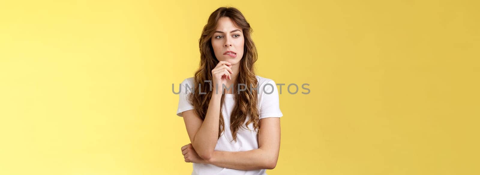Need think what do how solve situation. Perplexed focused serious-looking thoughtful woman pouting touch lip look away pondering deep thinking standing yellow background hesitant. Copy space