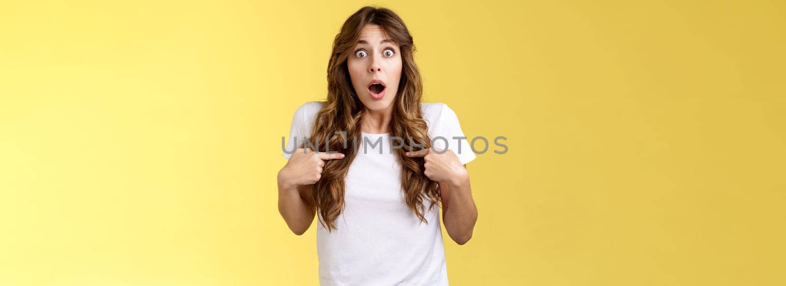 Shocked impressed speechless surprised girl gasping drop jaw pointing herself chest stare camera astonished unexpected promotion being chosen picked winning lottery stand yellow background by Benzoix