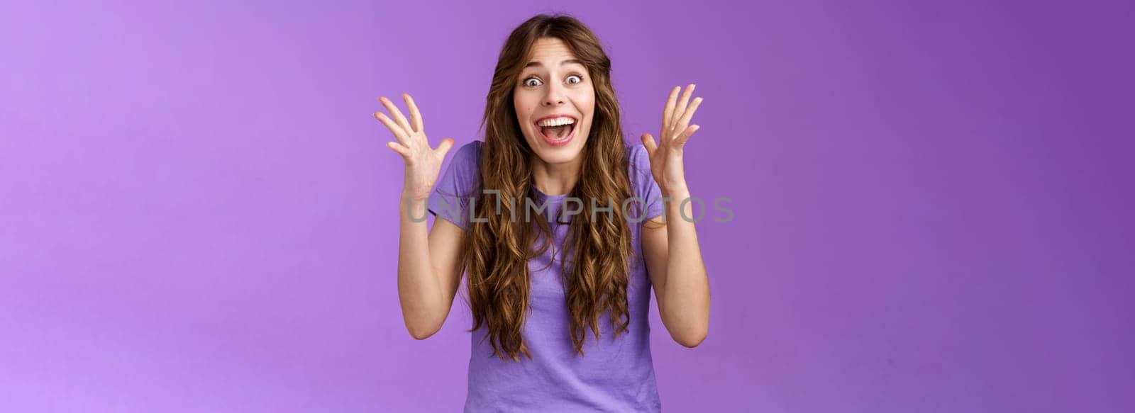 Cheerful surprised happy girl receive unbelievable super prize winning triumphing smiling joyfully shake hands excitement joy celebrating perfect news grinning happily victory purple background.