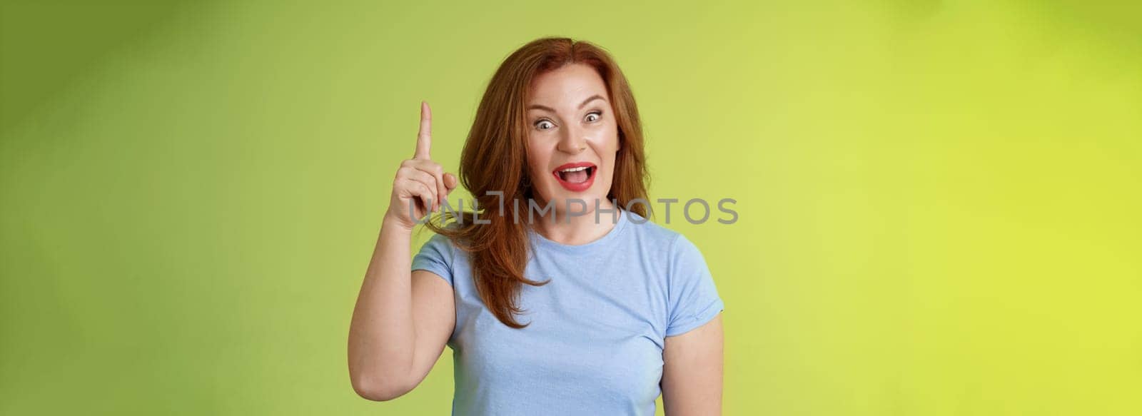 Got excellent idea solution up there. Excited smart creative middle-aged mature woman ginger hair raise index finger eureka pointing top explain offer terms smiling describe cool advertisement.