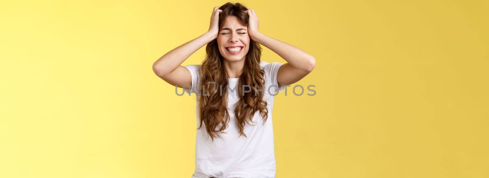 Girl feeling huge pain suffer heartbreaking break-up grab head panicking close eyes clench teeth anxiously troubled feel distress terrible situation stand yellow background hopeless grieving by Benzoix
