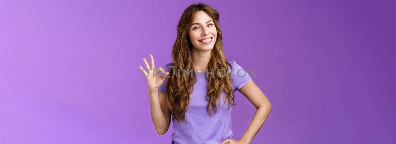Confident professional girl not scared difficult task assure everything okay smiling broadly self-assured pose hold hand hip show ok ring sign grinning accepting agree good terms purple background by Benzoix