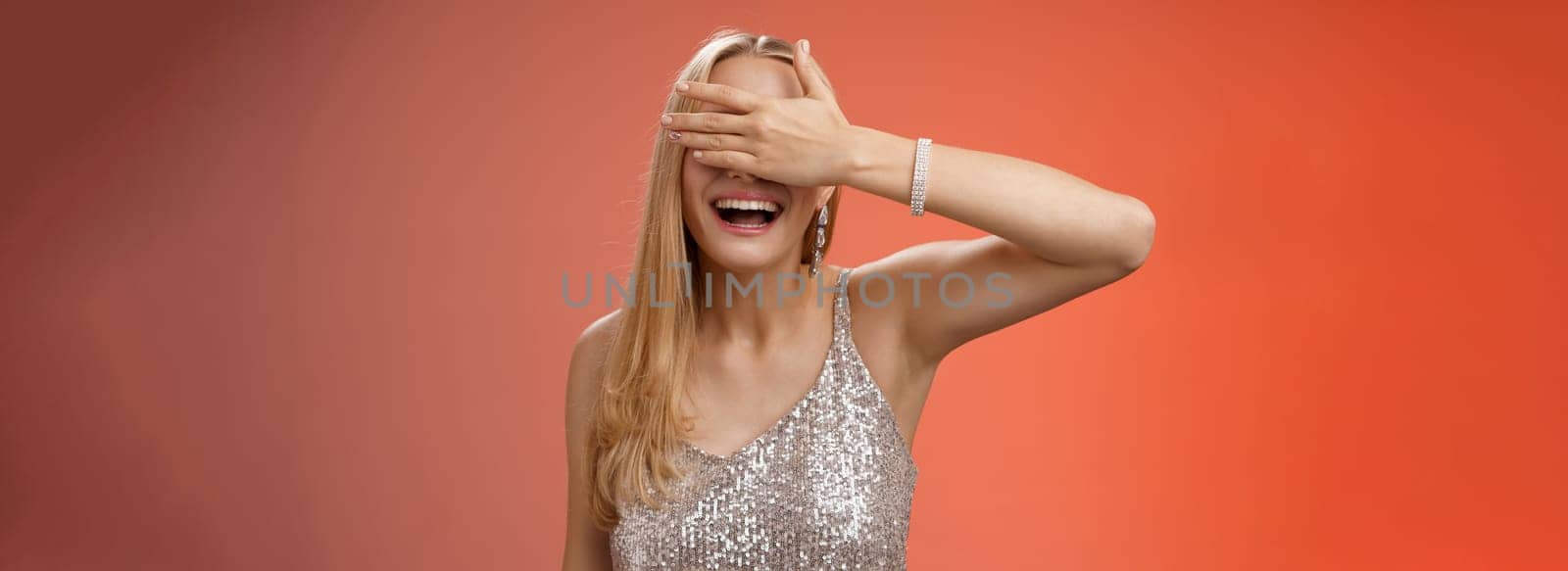Lifestyle. Charming lucky outgoing blond 25s birthday girl celebrate gather friends party night club wearing stunning silver glittering dress hide eyes close palm waiting surprise anticipating awesome gift.