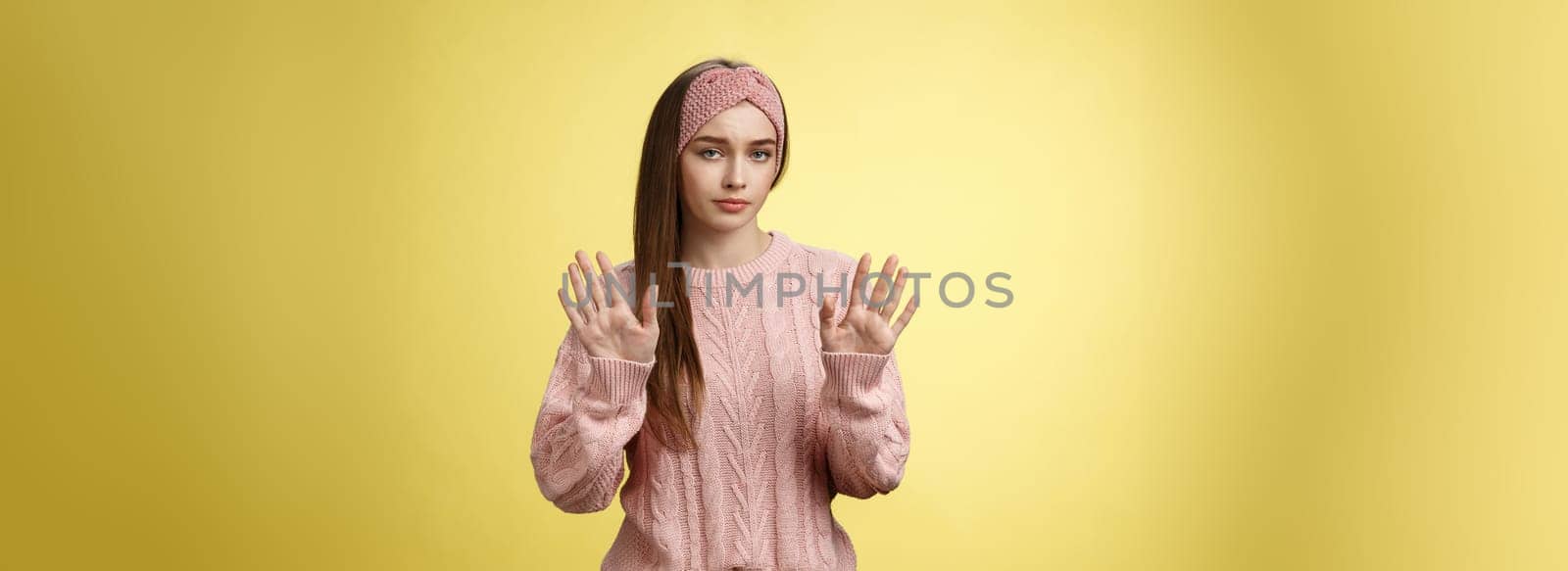 No thanks. Cute unamused picky young girl in knitted sweater, headband showing hold on, slow down, refusal gesture raising palms in rejection being reluctant unimpressed and indifferent to proposal by Benzoix