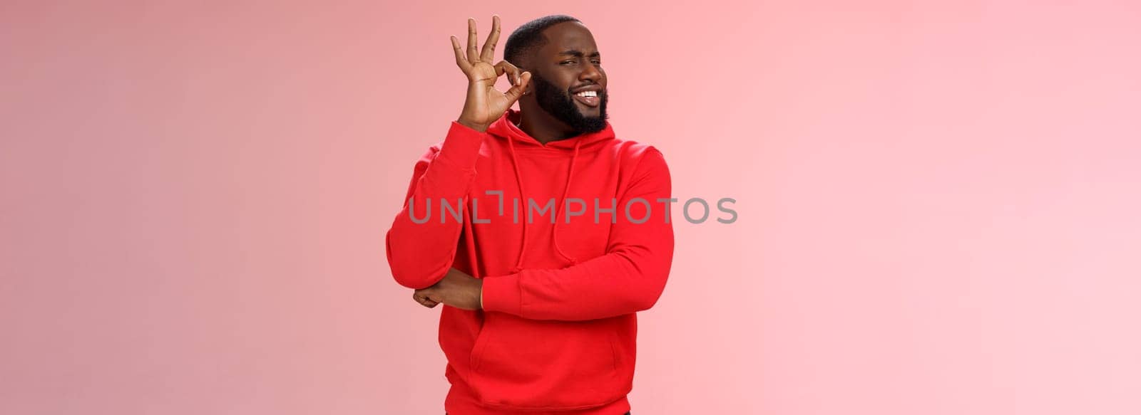 Attractive satisfied happy charismatic handsome male black customer very impressed recommend good quality service show okay ok perfection gesture smiling happily, pink background by Benzoix