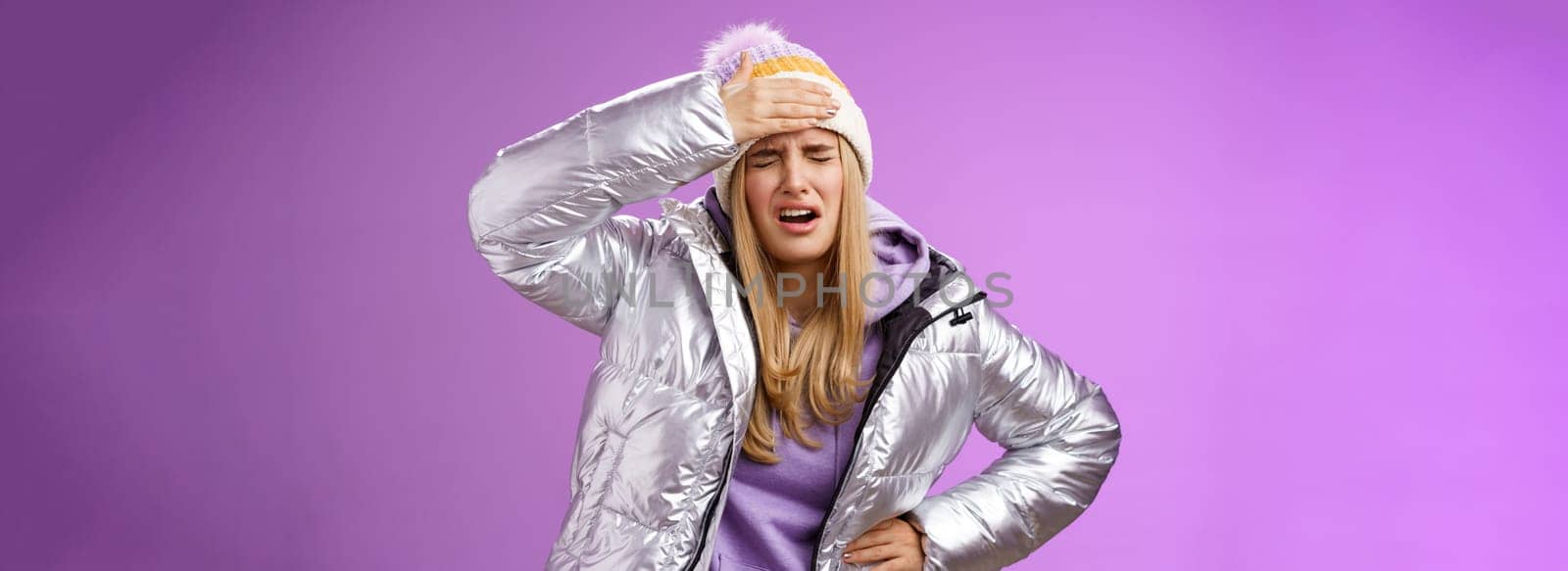 Girl sick tired touch forehead painful feeling grimacing complaining boyfriend shot snowball woman face standing bothered fed up and upset, whining displeased suffering headache, purple background.