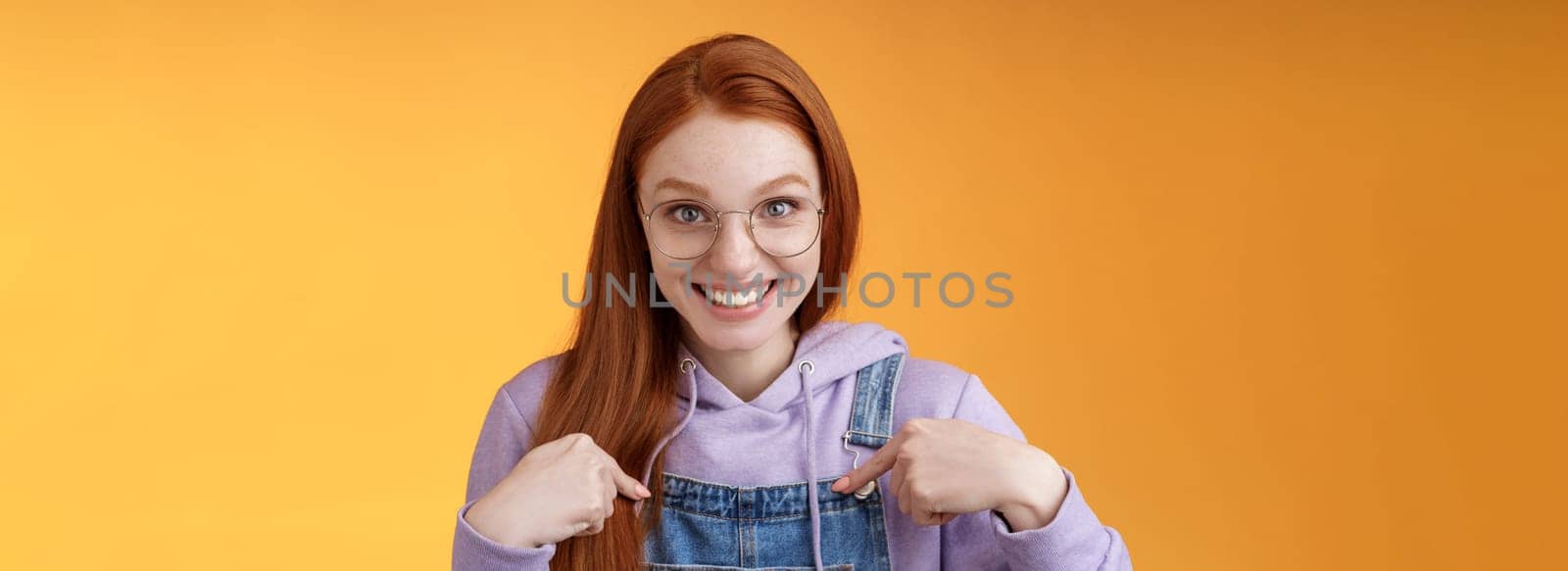 Surprised happy pleased happy smiling young redhead girl getting awesome proposal grinning questioned pointing herself laughing full disbelief receive promotion unbelievable chance. Copy space