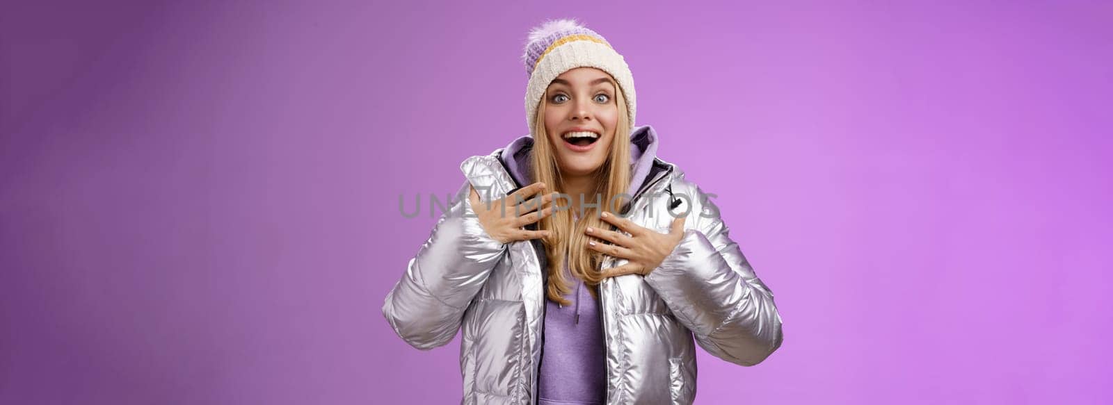 Grateful delighted young surprised girl receive unexpectedly good news feel lucky thrilled pointing herself press palms chest thankful smiling amused gasping speechless triumphing, purple background.