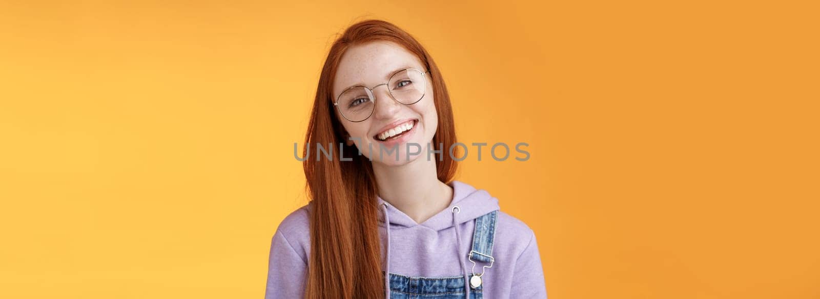 Wellbeing, lifestyle, people concept. Attractive friendly-looking smiling redhead young girl straight long natural ginger hair wearing glasses laughing happily enjoy nice relaxing cafe atmosphere.