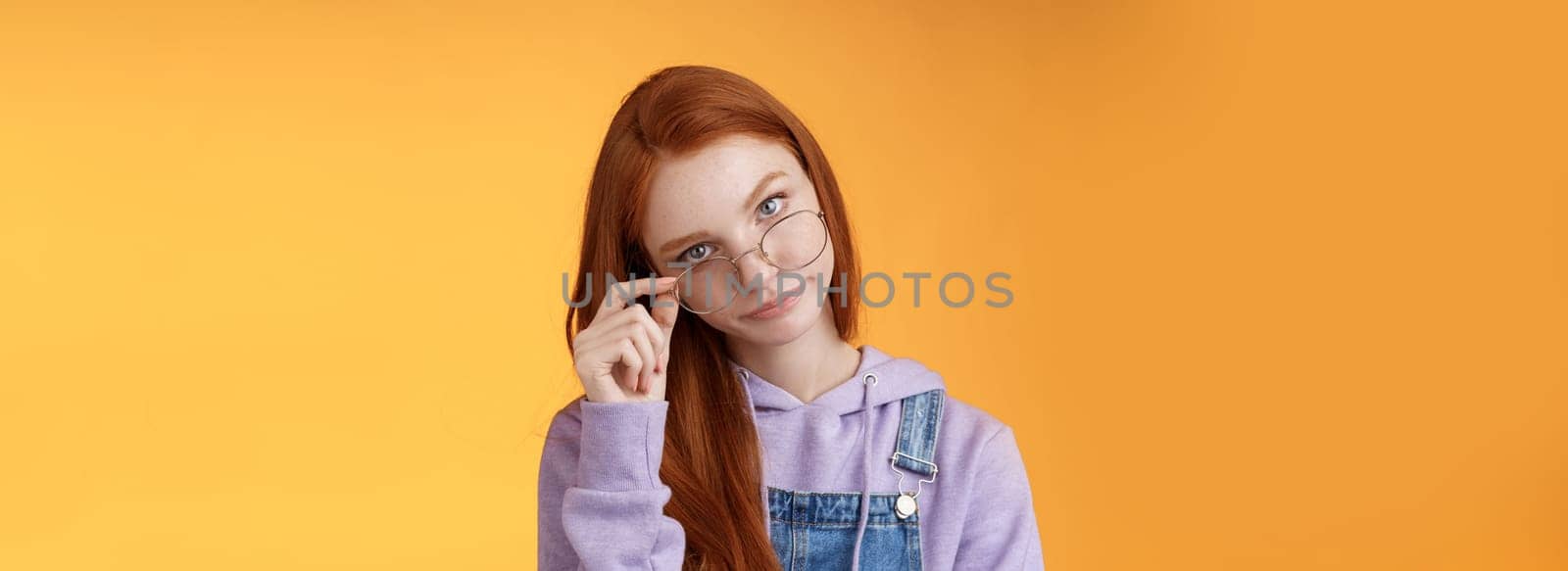 You gotta be kidding me. Annoyed redhead smart irritated elder sister look from under forehead take off glasses roll eyelids smirking disturbed pissed stupid jokes, standing orange background by Benzoix
