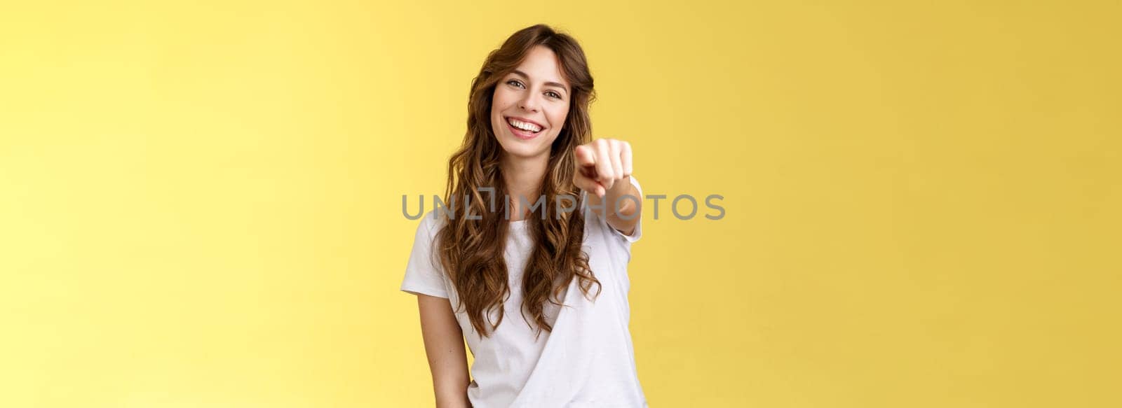 We need you. Cheerful outgoing cute caucasian enthusiastic girlfriend pointing camera asking join her team tilt head smiling broadly congratulate friend great effort stand yellow background.