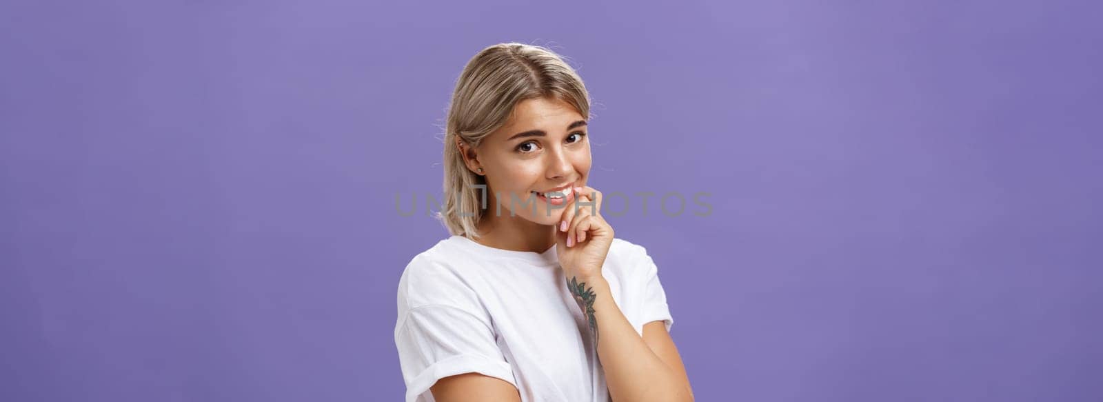 Girl making cute face to take what wants. Charming tender and gentle feminine girlfriend with tanned skin making silly expression smiling, touching lower lip with finger flirting or asking for favor.