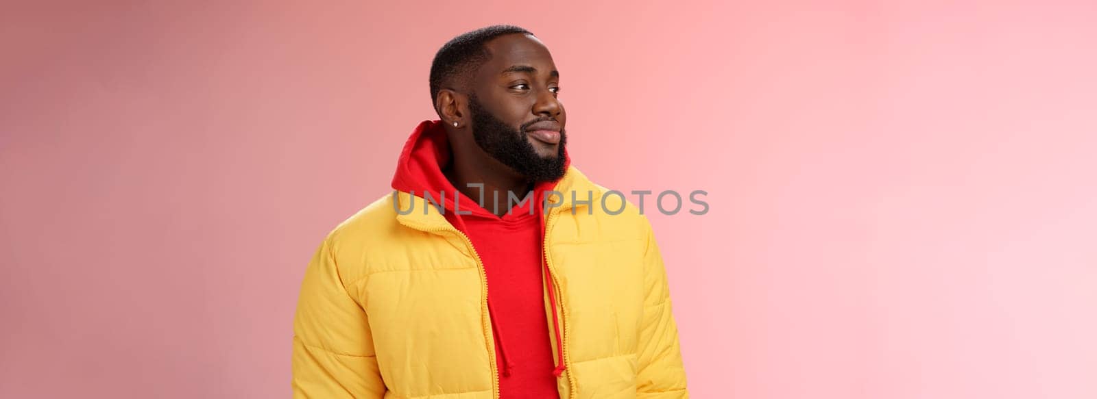 Dreamy happy optimistic black bearded man looking left daydreaming recalling nice moments, enjoying warm peaceful weather walking park feel calm relieved, standing pink background smiling cute.