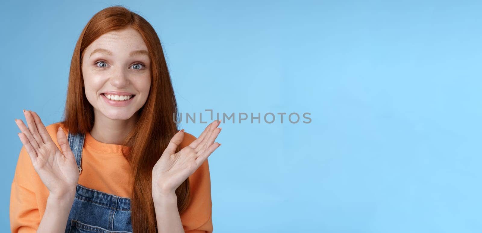 Proud happy supportive young redhead girl friend clapping hands gladly smiling congratulating girlfriend achieve success express happiness cheering attend awesome performance clasping happily by Benzoix