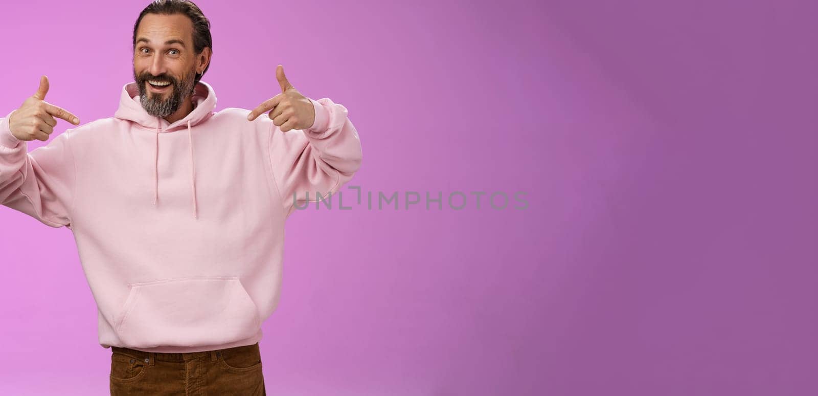 Energized good-looking cool hipster mature man bearded grey hair wrinkles pointing himself bragging accomplishments wanna participate offer help, suggest his candidature, standing purple background.