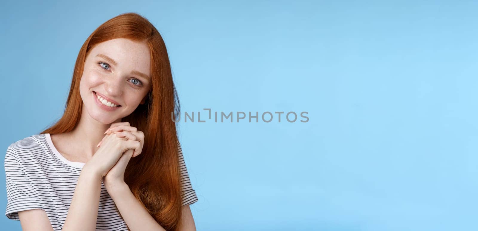 Romantic tender lovely redhead girlfriend tilting head press palms together smiling touched look sympathy check out cute picture friend standing delighted amused, heartwarming moment.