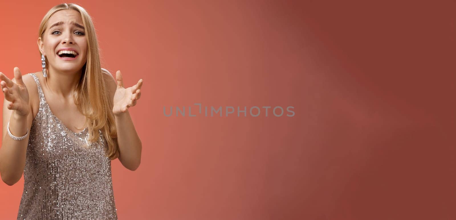 Panicking upset miserable heartbroken blond girl crying raising hands begging not go broke-up boyfriend look sorrow distressed freak-out standing devastated red background during party by Benzoix