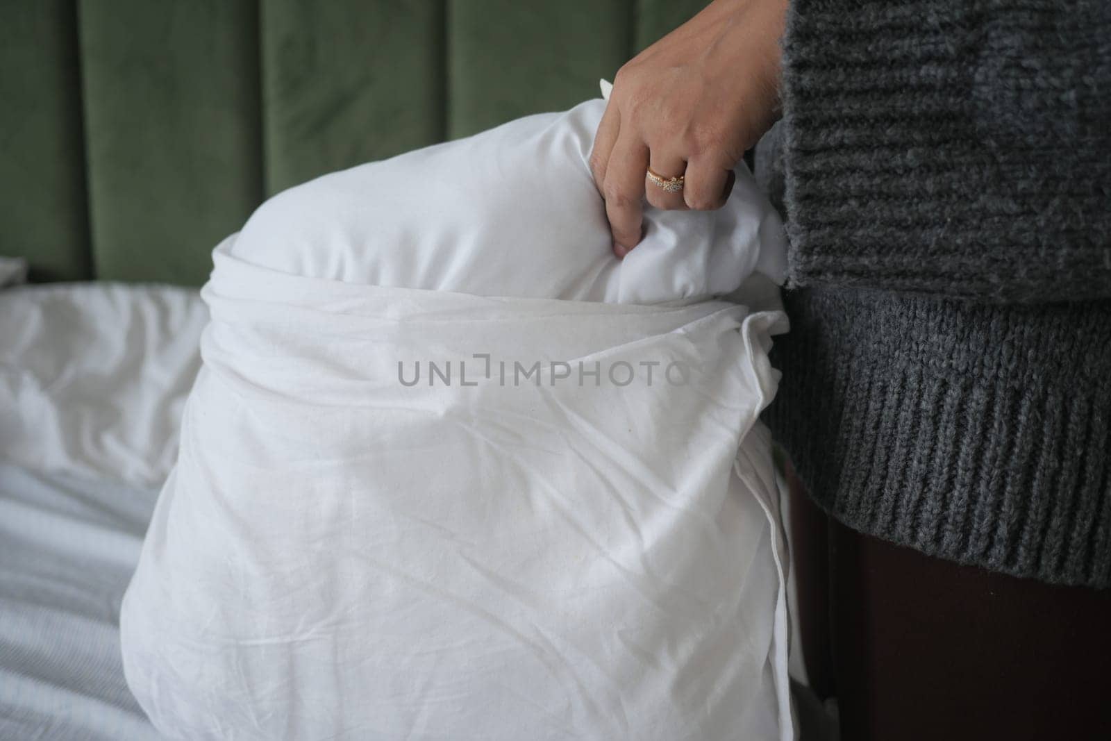 Woman Puts Pillow Into Pillowcase. by towfiq007