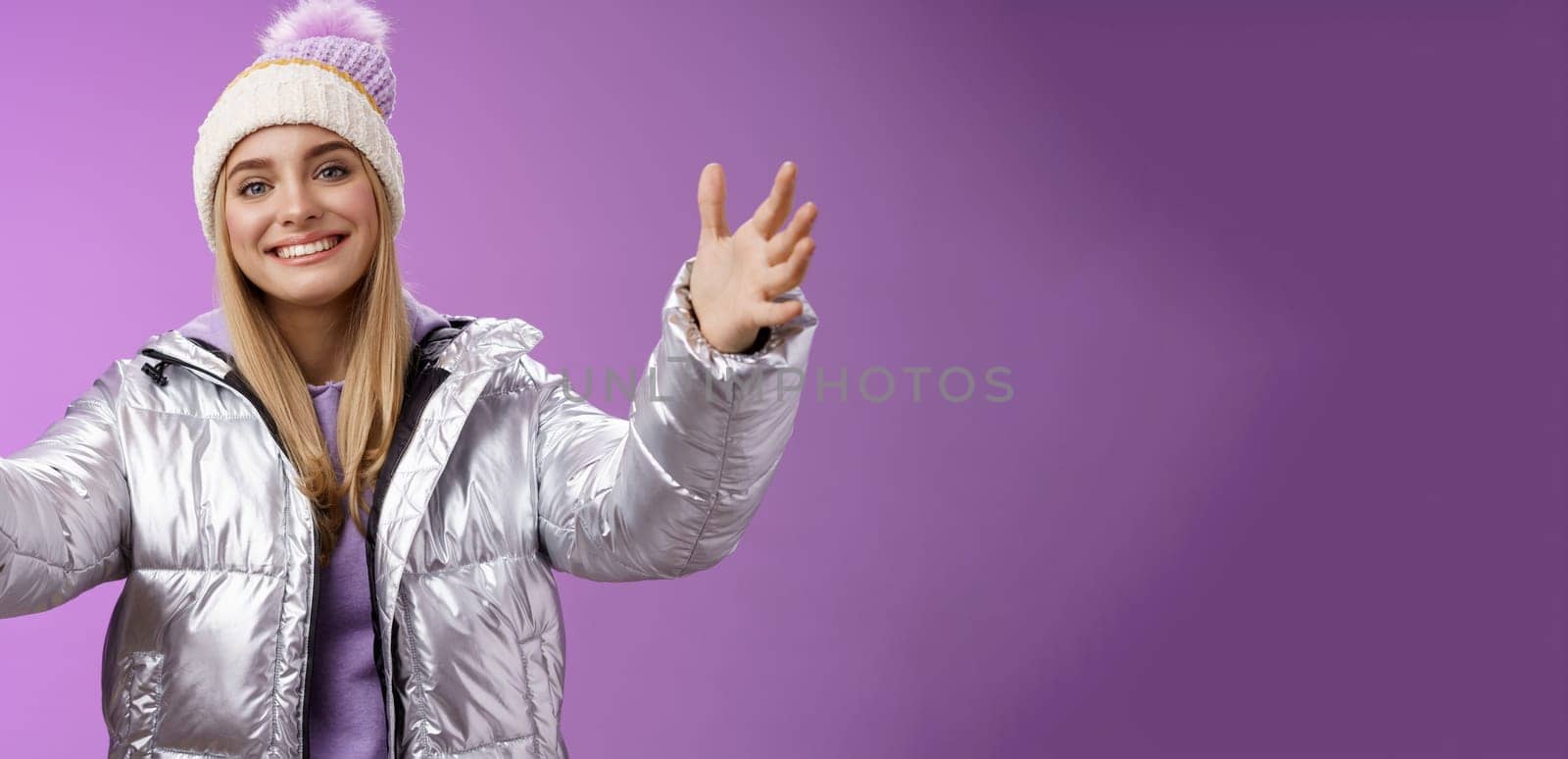 Friendly charming smiling european girl vacation wearing silver warm glittering jacket hat extend arms waiting girlfriend fall arms embrace loving person standing happily purple background by Benzoix