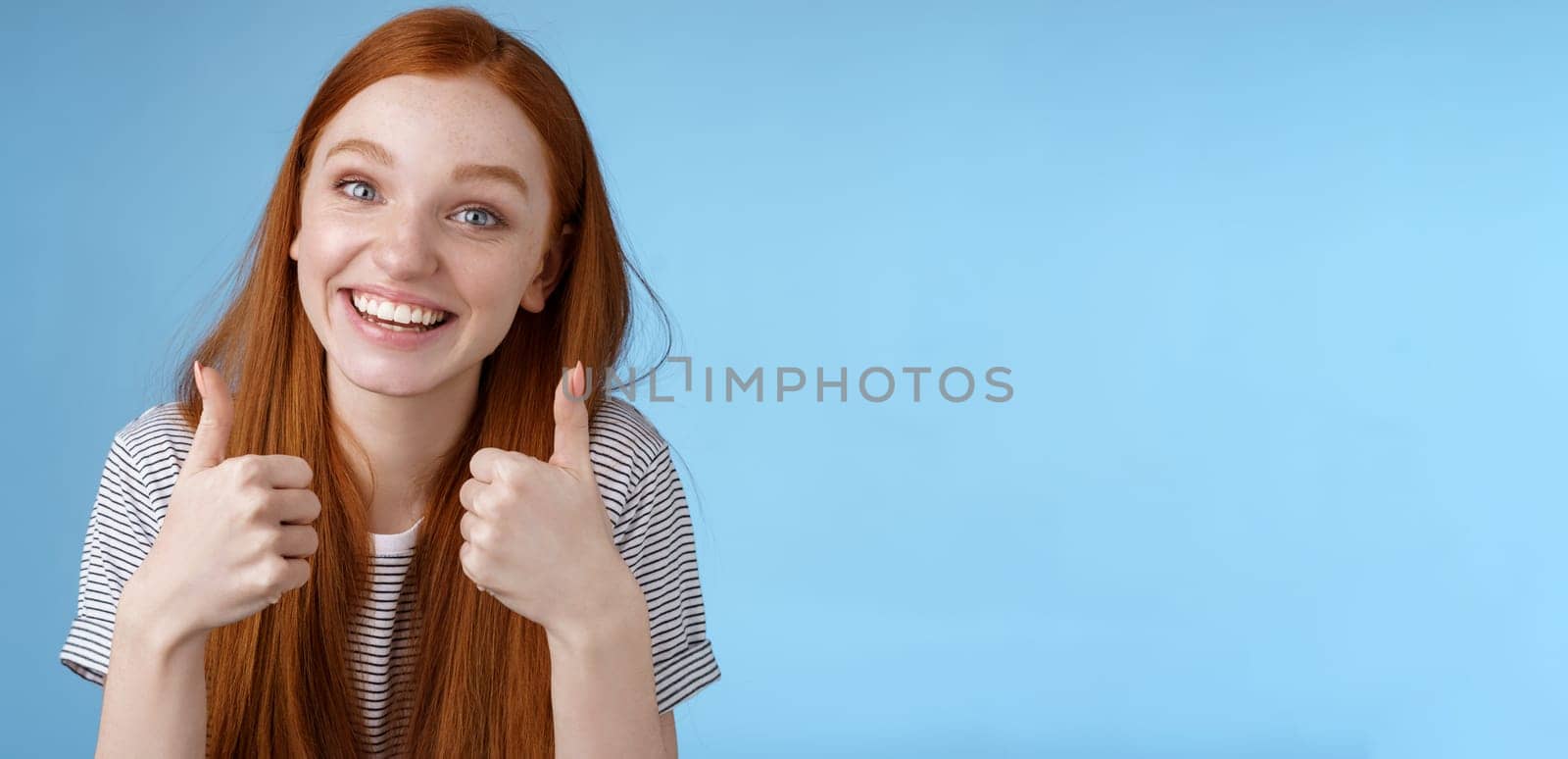 Nice idea keep up. Supportive tender cute european ginger girl blue eyes cheering friend boost mood show thumbs up smiling approval like good choice, agree interesting suggestion, satisfied by Benzoix
