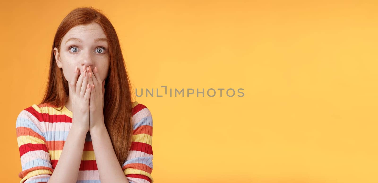 Shocked speechless impressed sensitive redhead european girl reacting stunning rumor gossiping find out secret gasping cover mouth palm stare camera astonished surprised, orange background by Benzoix