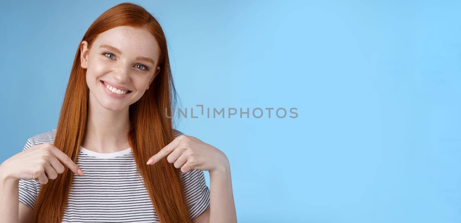 Visit place you love it. Friendly-looking kind gentle attractive redhead woman showing advertisement copy space pointing index fingers down tilting head smiling helpful recommend promo by Benzoix