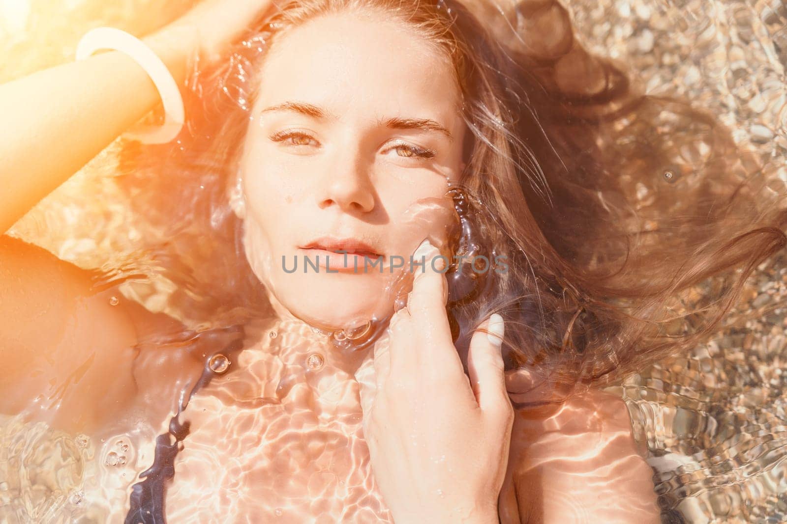 Woman summer travel sea. Happy tourist enjoy taking picture outdoors for memories. Woman traveler posing on the beach at sea surrounded by volcanic mountains, sharing travel adventure journey by panophotograph