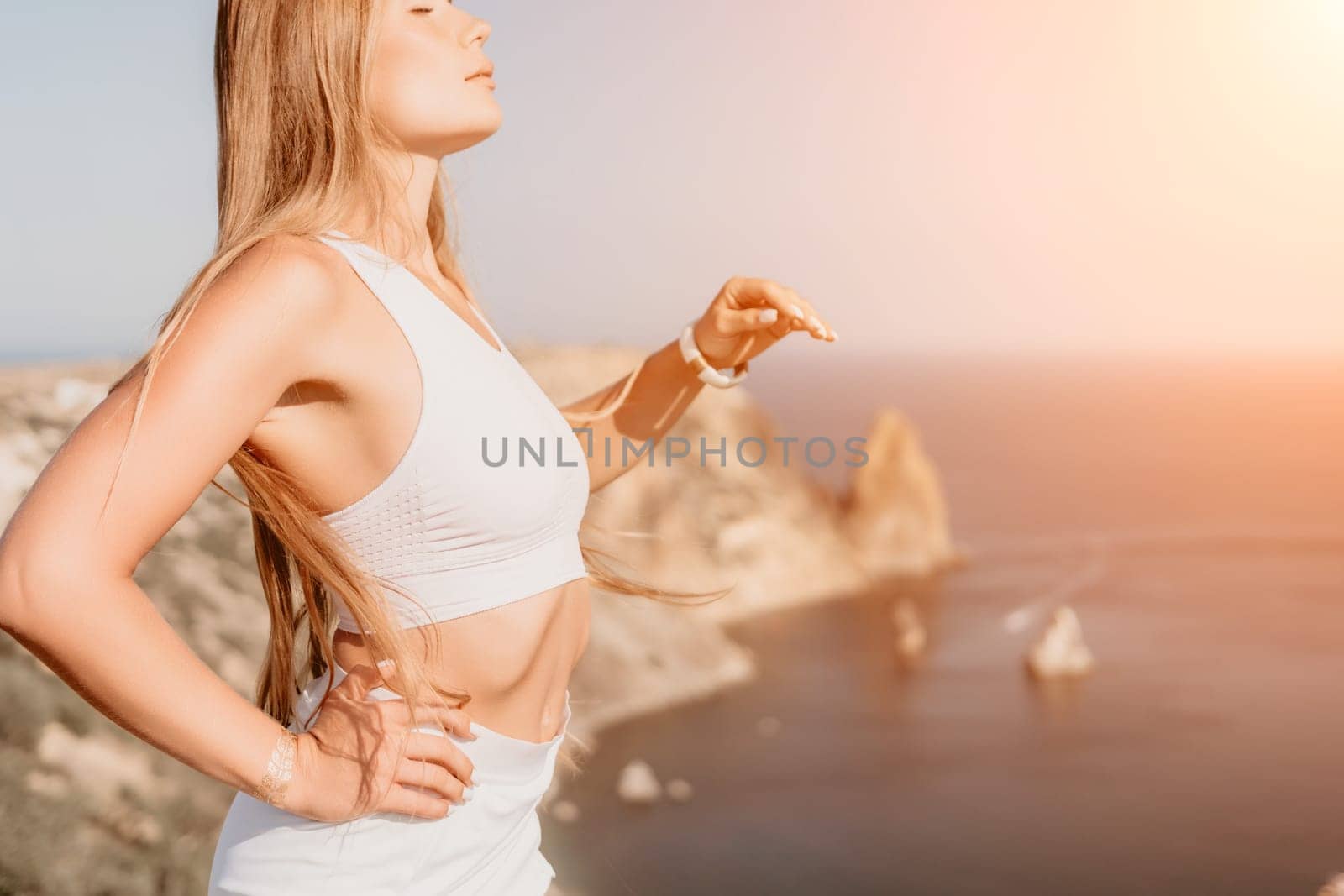 Woman summer travel sea. Happy tourist in hat enjoy taking picture outdoors for memories. Woman traveler posing on the beach at sea surrounded by volcanic mountains, sharing travel adventure journey by panophotograph