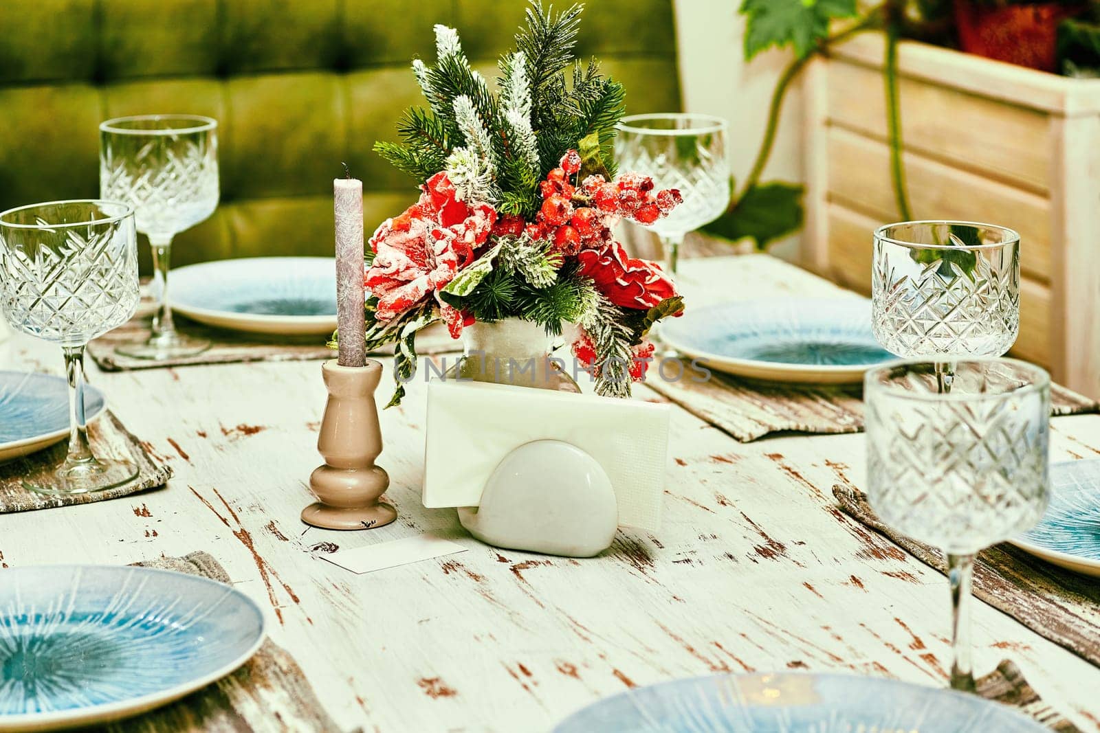 the annual Christian festival celebrating Christ's birth, held on December 25 in the Western Church. Festive New Year's Christmas table with candles and dishes close up. High quality photo