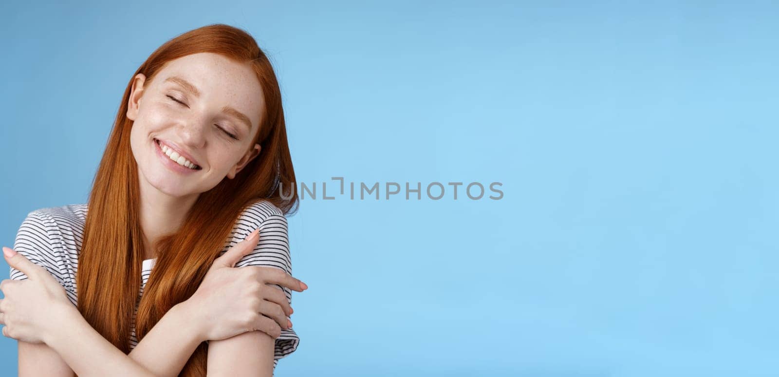 Lifestyle. Tender romantic cute young gentle redhead girlfriend close eyes dreamy lean shoulder cross arms around chest cuddling recalling nice memory feel warmth comfort hugging daydreaming smiling.